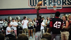 Thompson High School football player Alijah Steele hoists the Game Ball trophy after receiving it from Pelham Mayor Gary Waters during a Sept. 11 pep rally at THS. (Reporter Photo/Neal Wagner)