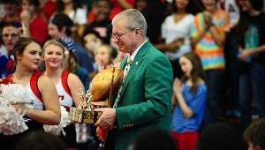 Pelham Mayor Gary Waters grimaces as he prepares to turn over the Game Ball trophy during a Sept. 11 pep rally at Thompson High School. (Reporter Photo/Neal Wagner)