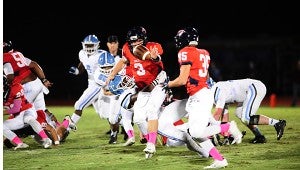 Oak Mountian quarterback Warren Shader (3) pitches the ball as he is tackled to Coleman Reeves (35) during the Eagles' 20-10 loss to the Jaguars at Heardmont Park. (Reporter Photo/Neal Wagner)