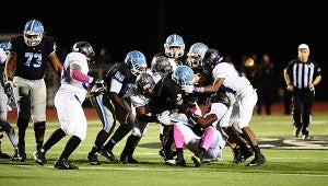 Sophomore running back D’Aire Johnson (3) is wrapped up by Bessemer City’s defense during the Jags’ 24-6 victory over the Purple Tigers on Oct. 30. Johnson had a career night during the game. (Reporter Photo/Neal Wagner)