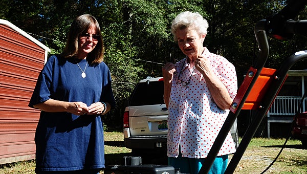 Alabaster resident Carolyn Ledbetter, right, is overjoyed as Suzi Daniels, left, presents her with a new tiller purchased through a community fundraiser. (Reporter Photo/Neal Wagner)