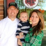 Area 41 Pizza Company owner Patrick Hankins stands with his wife, Autumn, and 1 year-old son, Grey. (For the Reporter / Dawn Harrison)