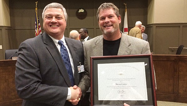 Alabaster School Superintendent Dr. Wayne Vickers, left, congratulates THS engineering teacher Brian Copes, right, for receiving the President’s Lifetime Achievement Award on Nov. 9. (Reporter Photo/Neal Wagner)