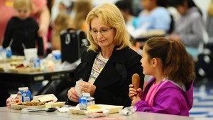 Lynn Robertson enjoys a Thanksgiving lunch with her granddaughter, Kelsey Galloway, at Meadow View Elementary School on Nov. 18. (Reporter Photo/Neal Wagner)