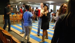 Sensi Keith MacConkey gives a student pointers on proper form during a Dec. 9 self-defense class at the Spain Park library. (Reporter Photo / Molly Davidson)