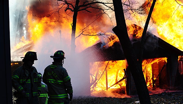     Alabaster and Calera firefighters spray water to control a blaze during a Dec. 4 controlled burn at an abandoned house off U.S. 31. (Reporter Photo/Neal Wagner)