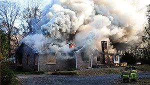     Fire begins to fully engulf an abandoned house during a Dec. 4 controlled burn. (Reporter Photo/Neal Wagner)