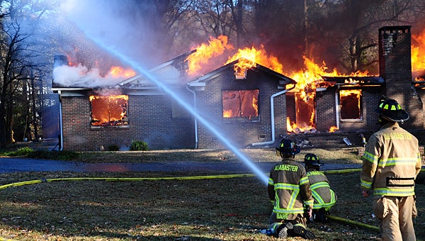 Alabaster firefighters work during a Dec. 4 controlled burn off U.S. 31. The city’s fire protection rating recently improved significantly. (Reporter Photo/Neal Wagner)