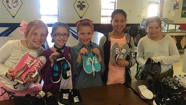 Thompson Intermediate School students enjoy a sock hop on Dec. 10, during which students donated new shoes to benefit students in Honduras. (Contributed)