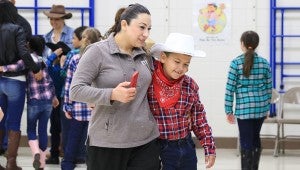 Jenna Peña congratulates her son, Cesar, after his performance on Jan. 20. (For the Reporter / Dawn Harrison)